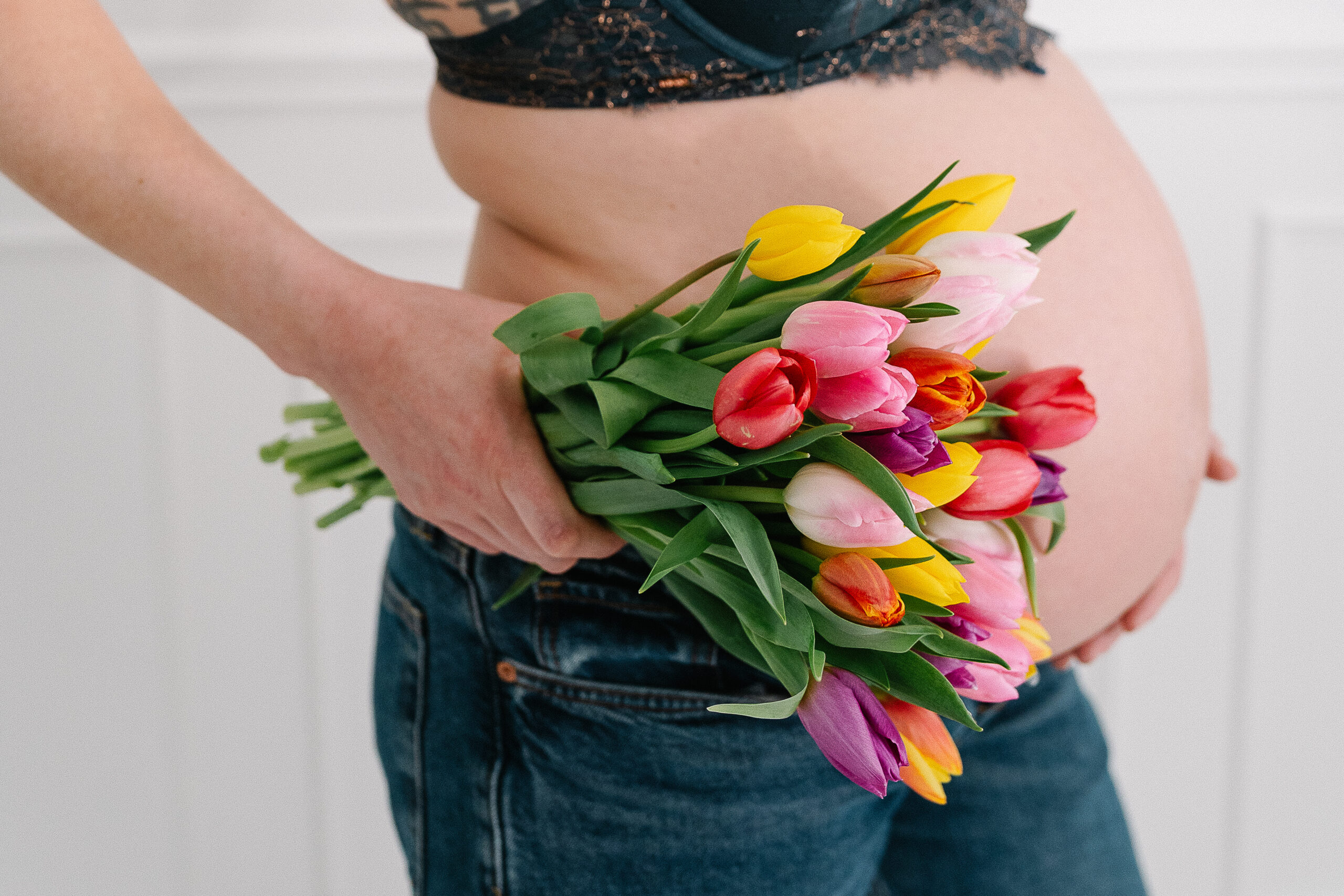 Photographe grossesse à Reims – lumière naturelle ventre rond et tulipes